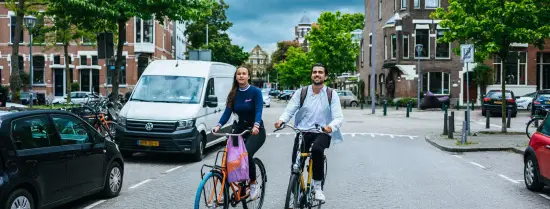 Twee studenten die samen fietsen