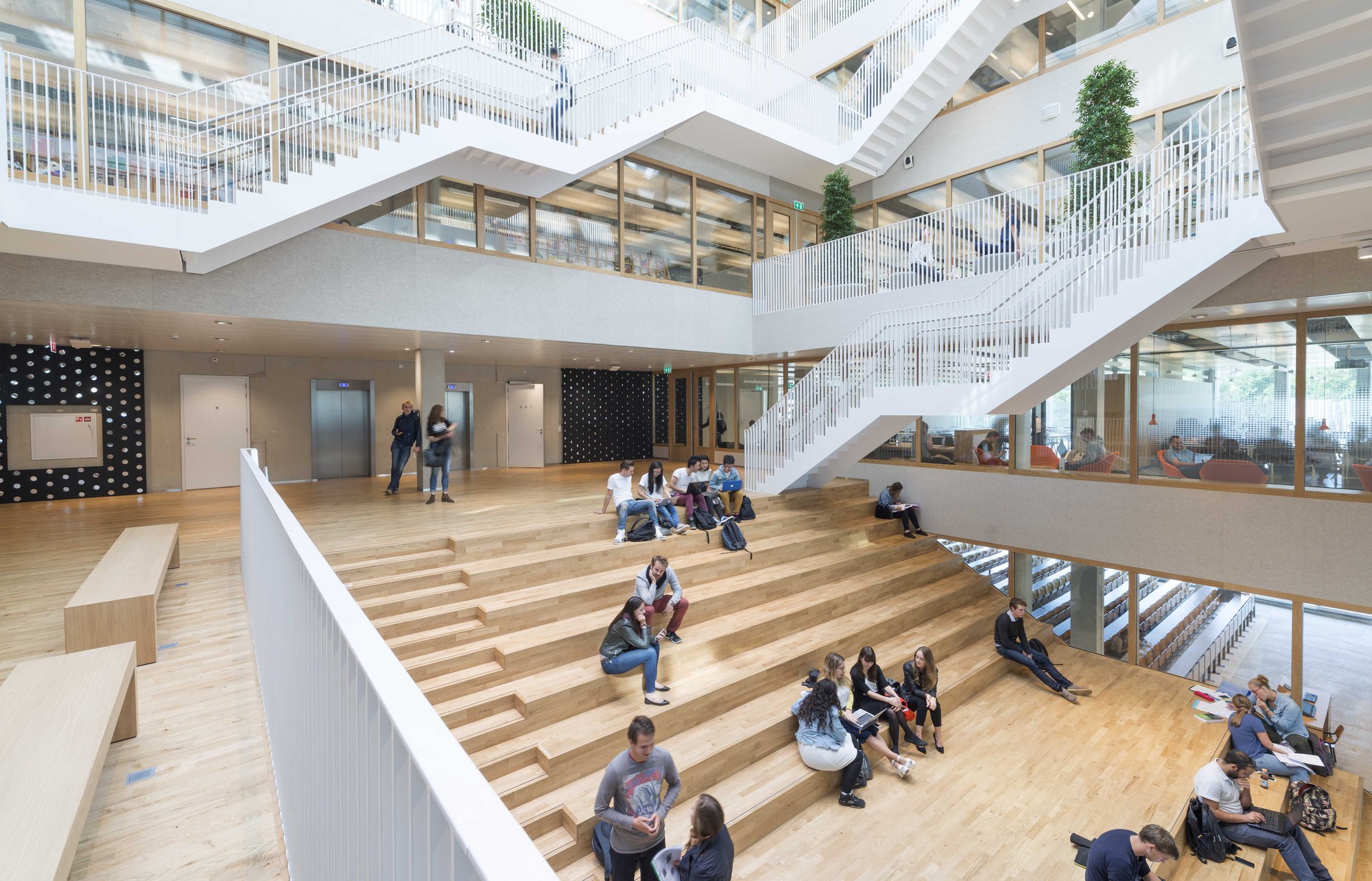 Students sitting on the stairs in Polak building at Woudestein Campus