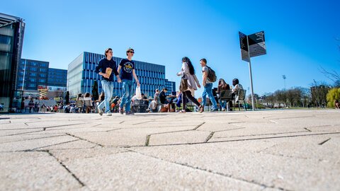 students walk across campus