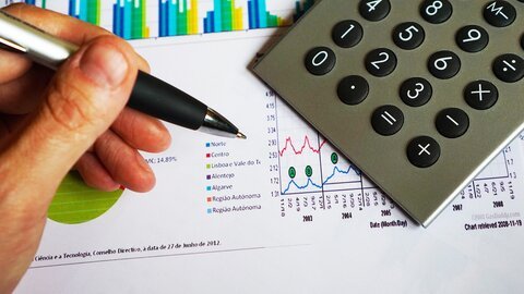 Image of a hand working with a calculator