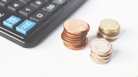 Stacks of euro with a calculator