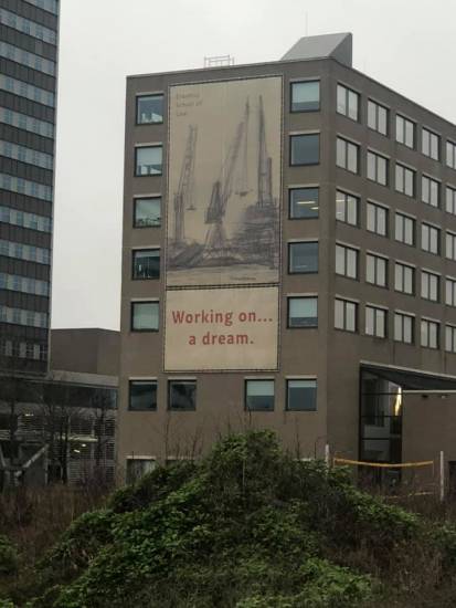 Banner reading 'working on a dream' on campus