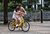 Father teaches child how to ride a bike.