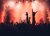 Pop concert: dark silhouettes, red colors, mist and hands in the air