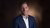 Bas Karreman in a suit looking at the camera