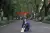Photo of Xiaoyu Zhang sitting in a street