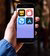 A hand holding a smartphone with gay dating apps