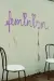 two chairs in front of a wall, the word feminism written on the wall
