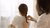 A person braiding the hair of a child