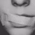 A mouth covered by a plaster