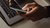 crop faceless person using laptop and smartphone in darkness