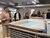 Alumni gathering around a drawing in depot of Nieuwe Instituut during ESHCC alumni event