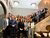 Grote groep medewerkers poseert op een trap tijdens de Strategy Days 2024 in Brussel.