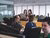 A workplace with several employees talking and working.