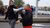 Housing activist Mustapha Eaisaouiyen walks through the city while talking through a megaphone.