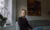 Woman sitting in a living room, looking out the window