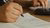 Person writing on paper