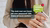 woman holding smartphone with green chat bubble reading Dutch job offer text.