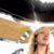 Curly blonde woman with dangling earrings gazes upward under reflective patterned canopy.