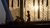 A dark silhouette of a person jogging on the Erasmus Bridge