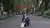 Photo of Xiaoyu Zhang sitting in a street