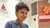Photo of Renza Iqbal with a smartphone in her hand sitting on steps