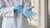 Hospital worker puts on disposable rubber gloves