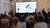 An audience of potential investors attends a presentation about Art Inception