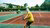 Person seen from behind in yellow T-shirt with tennis racket on tennis court.