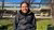 Atakan sitting on a bench on campus Woudestein