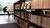 Low metal bookshelves filled with books from the Leeskabinet. Students are reading in the background.