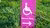 Sign on grass, indicating step free route for wheelchair users