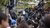 Crowd of journalists holding up camera gear