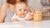 Curious child stretching arm towards peanutbutter jar