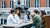students sitting at a table and drinking coffee