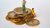 Two small human figures sitting and standing on a pile of Euros