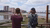 Two people looking in the distance with binoculars