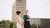 Two students walking and talking on campus.