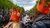 Two young women looking across a canal on Kingsday in amsterdam