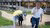 PhDs of Rinnooy Kan walking with Erasmus School of Economics umbrella
