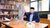 Hendrawan Supratikno sitting behind the desk of Jan Tinbergen and pointing towards his cardboard cutout