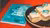The cover of the book is shown, next to cakes with the cover of the book on them