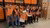 Nine EUR employees who helped one at the Food Bank pose in a row with a smile.
