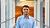 Student Giovanni Smargiasse is standing in the middle of a hall at the university wearing a blue blouse