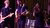 Person singing and two people are playing the guitar