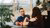 Two employees are chatting with each other whilst drinking coffee