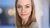 Blond woman looking into camera