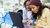 Two children are using their laptop outside