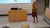 Female researcher with long blonde hair stands lecturing in a lecture hall.