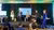 4 people sitting on a stage with a host